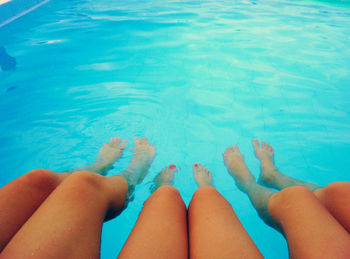 Woman’s legs in swimming pool