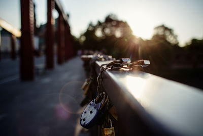 Close-up of padlock on railing in city