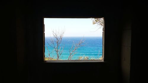 View of sea through window