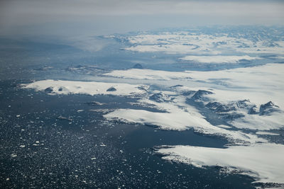 Aerial view of snowcapped mountain against sky