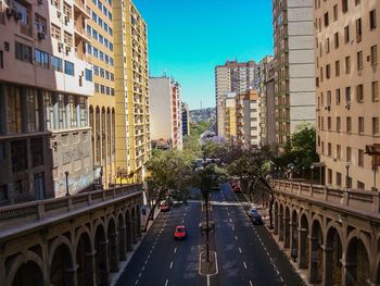 Street amidst buildings against clear sky