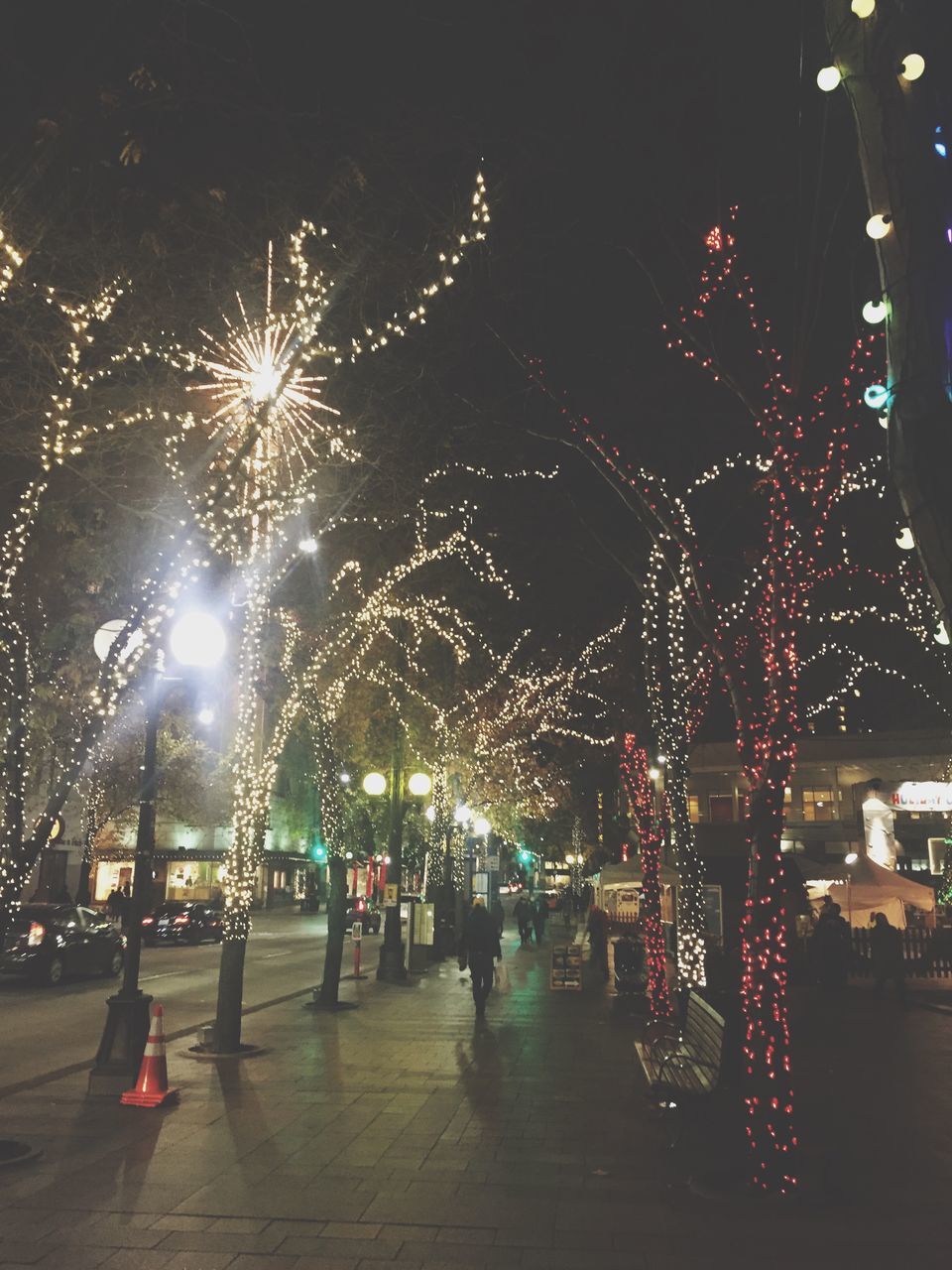 illuminated, night, celebration, arts culture and entertainment, lighting equipment, large group of people, leisure activity, street light, motion, lifestyles, firework display, building exterior, city, person, incidental people, amusement park, event, long exposure, city life