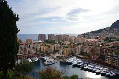 High angle view of buildings and sea against sky