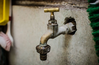 Close-up of faucet against wall