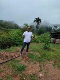 Full length of man standing on field against sky