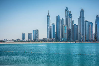 Sea with buildings in background