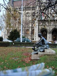 Statue against trees in city