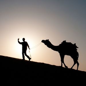 Silhouette of woman against clear sky