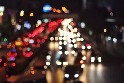 High angle view of defocused illuminated lights in city at night