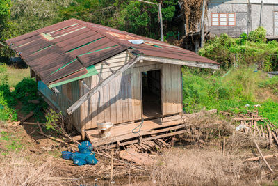 Old abandoned house on field by building