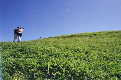 Rear view of man standing on hill