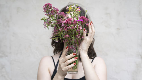 Woman holding bouquet of pink flowers 