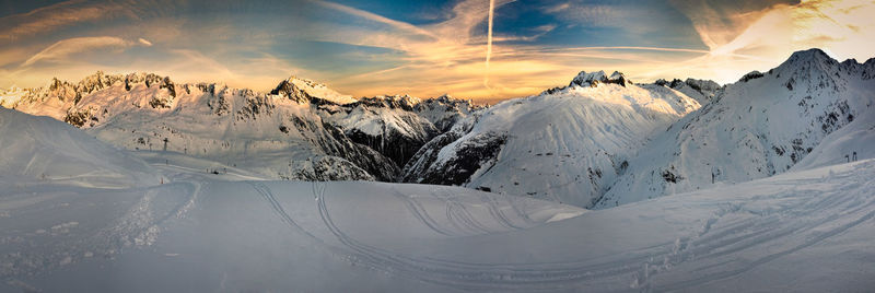 Scenic view of snowcapped mountains against sky during sunset