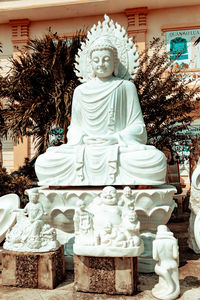 Statue of buddha against trees