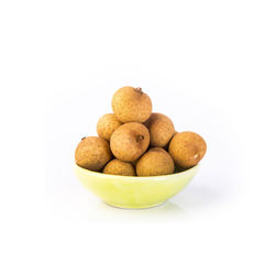 Close-up of fruits in bowl against white background