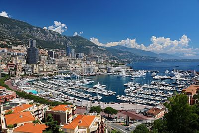 High angle view of townscape by sea against sky