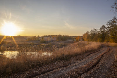 Scenic view of field against sky during sunset