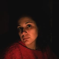 Portrait of beautiful young woman in darkroom