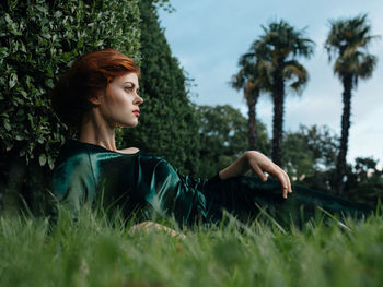 Woman looking away on field