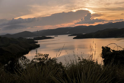 Scenic view of lake against sky during sunset