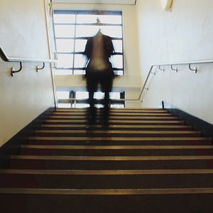 Rear view of man on staircase