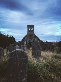Old ruin on field against sky