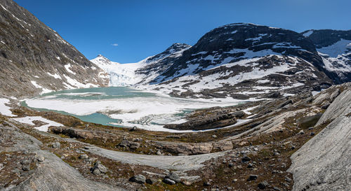 Scenic view of snowcapped mountains against clear blue sky