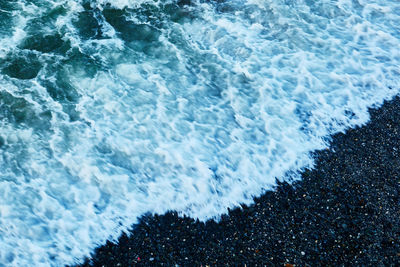 High angle view of waves rushing towards shore