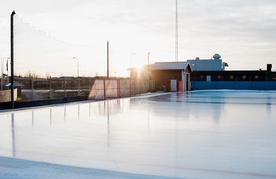 An empty outdoor ice rink at sunset in sweden