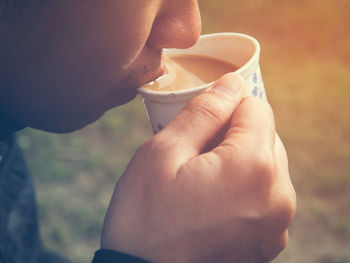 Close-up of man drinking tea