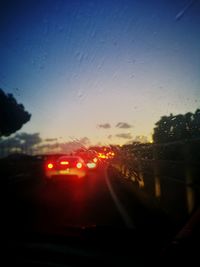 Cars on road seen through wet window