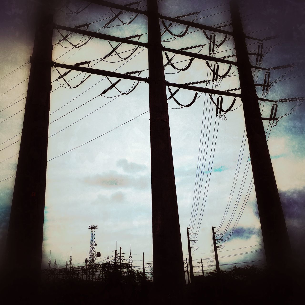 low angle view, silhouette, sky, power line, electricity pylon, power supply, electricity, fuel and power generation, connection, cable, dusk, cloud - sky, bare tree, technology, tree, nature, cloud, sunset, outdoors, cloudy