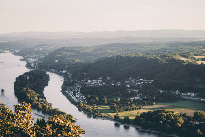 Scenic view of river by city against sky