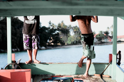 Low section of people walking on shore