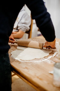 Midsection of person working on cutting board