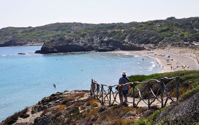 High angle view of man standing on footpath against mountains at balearic islands