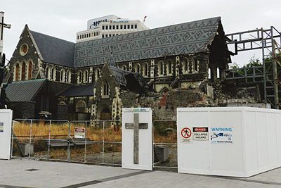 Information sign in city against sky