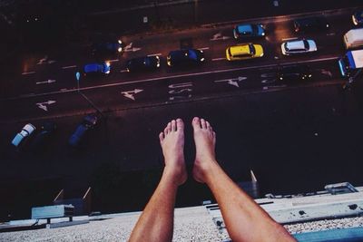 Low section of woman relaxing on tiled floor