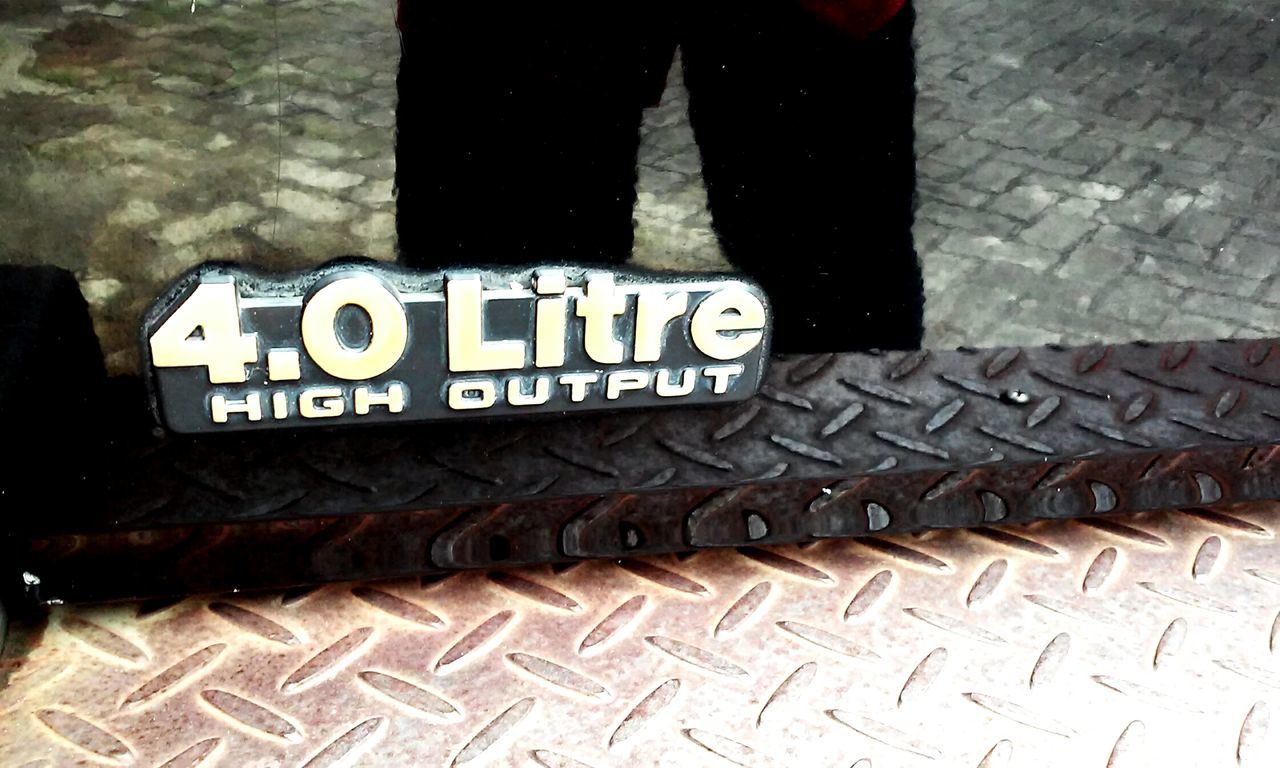 text, western script, communication, capital letter, high angle view, non-western script, street, information, low section, shoe, sign, outdoors, number, day, sidewalk, close-up, guidance, sunlight