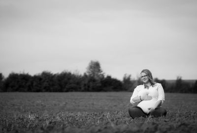 Woman sitting on field