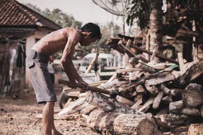 Man working on log