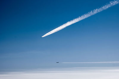 Low angle view of airplane flying in sky