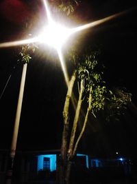 Low angle view of illuminated street light against sky