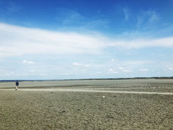 Scenic view of beach against blue sky