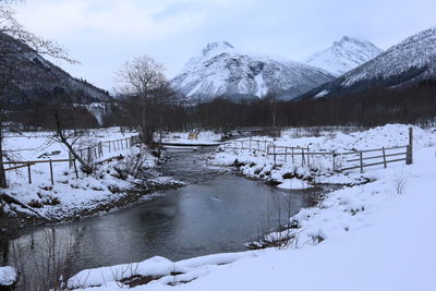 Scenic view of snow covered mountains against sky