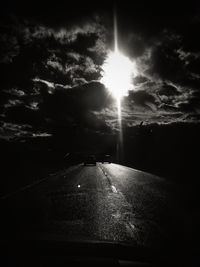 Road amidst trees against sky