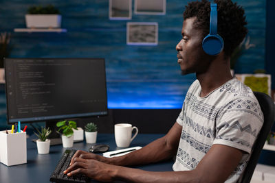 Young man using laptop at table