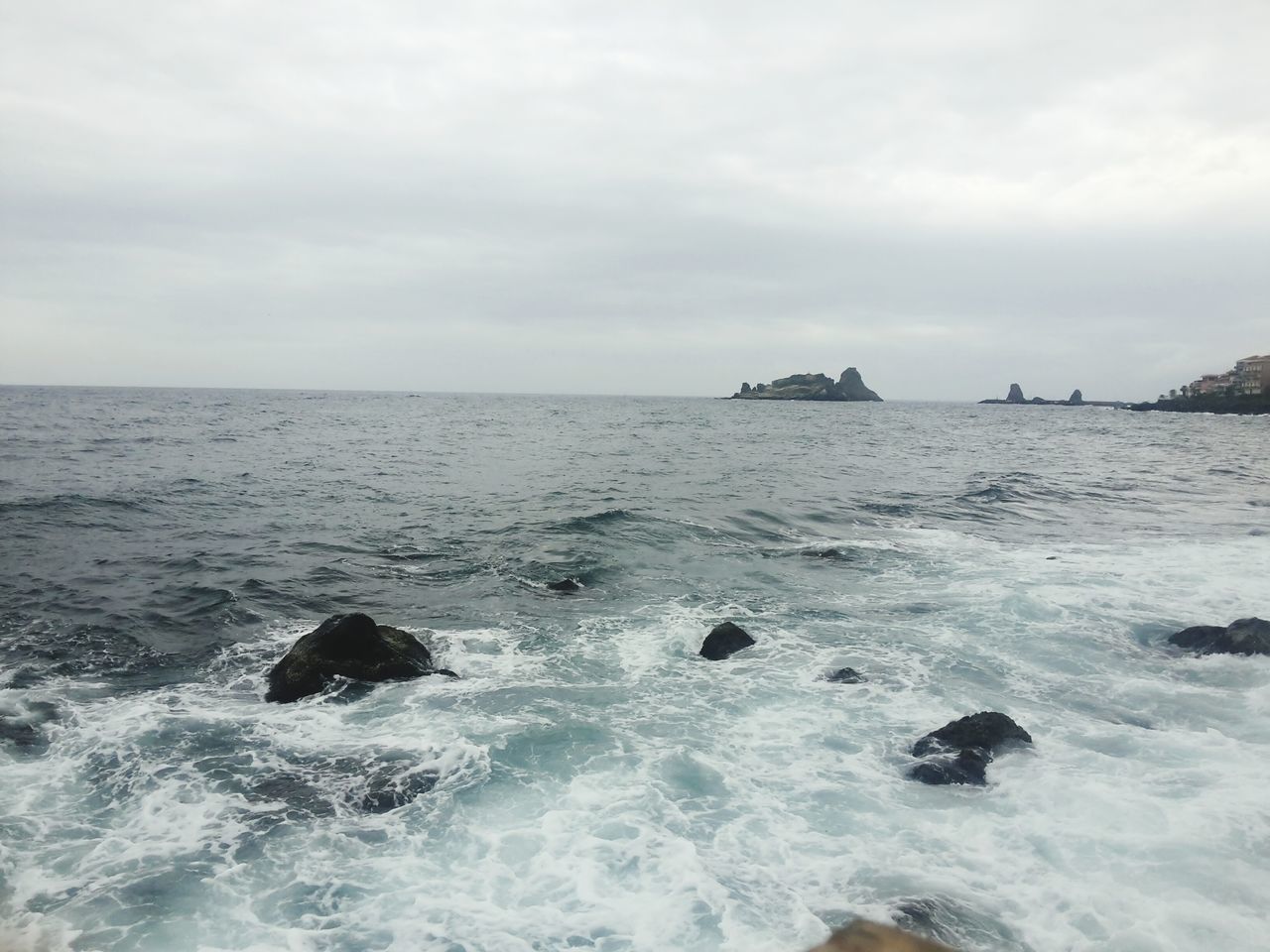 sea, water, horizon over water, sky, scenics, beauty in nature, wave, waterfront, tranquil scene, nature, tranquility, cloud - sky, surf, rock - object, cloudy, idyllic, seascape, rippled, motion, day