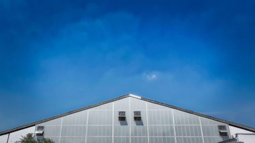 Low angle view of building against blue sky