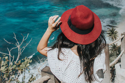 Rear view of woman wearing hat at beach